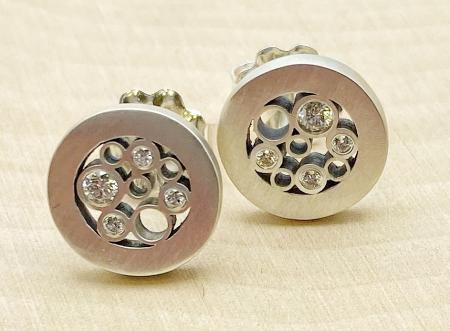 Sterling silver and diamond circle stud earrings. $750.00