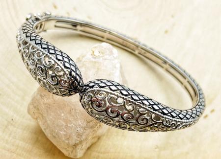 Sterling silver open swirl design bangle bracelet. $400.00