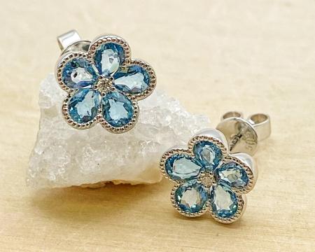 14 karat white gold flower design blue topaz and diamond earrings. $935.00