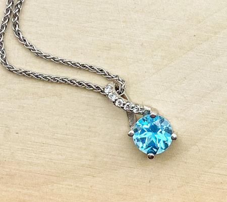 14 karat white gold Swiss blue topaz and diamond necklace. $790.00