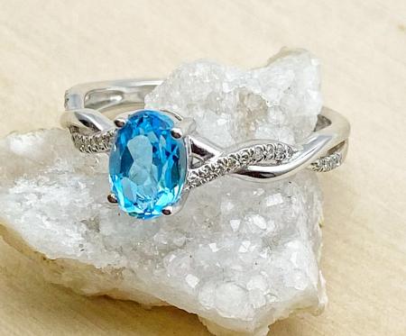 14 karat white gold infinity design Swiss blue topaz and diamond ring. $810.00