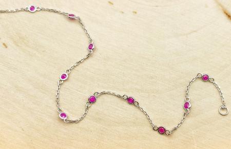 14 karat white gold ruby station bracelet. $420.00