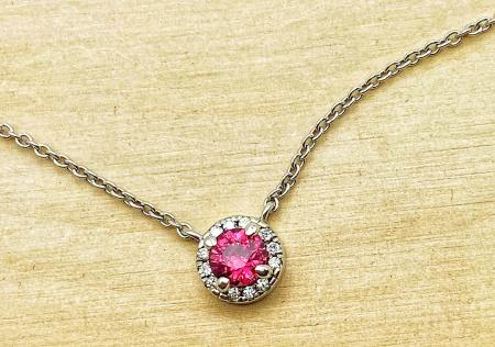 14 karat white gold round ruby and diamond halo necklace. $950.00