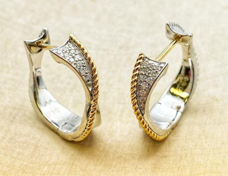 Sterling silver and 18 karat yellow gold diamond hoop earrings. $500.00