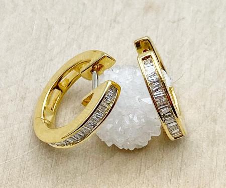 18 karat yellow gold baguette diamond hoops. $1250.00