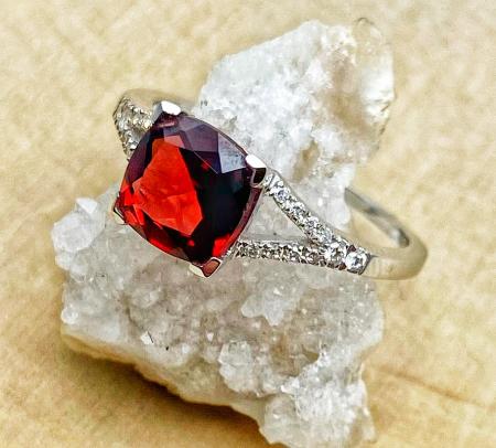 14 karat white gold cushion cut garnet and diamond ring. $790.00