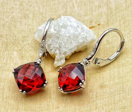 14 karat white gold cushion cut garnet and diamond earrings. $835.00