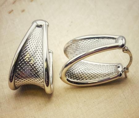 Sterling silver textured hoop earrings. $170.00