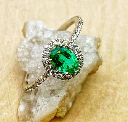 14 karat white gold oval faceted emerald and diamond ring. $3375.00