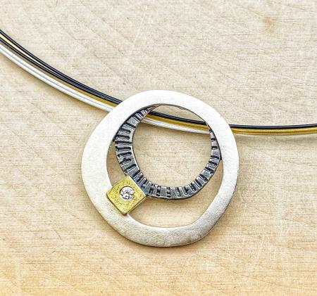 Oxidized sterling silver, 18 karat gold and diamond double circle necklace. $260.00