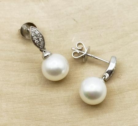 14 karat white gold freshwater cultured pearl and diamond earrings. $800.00