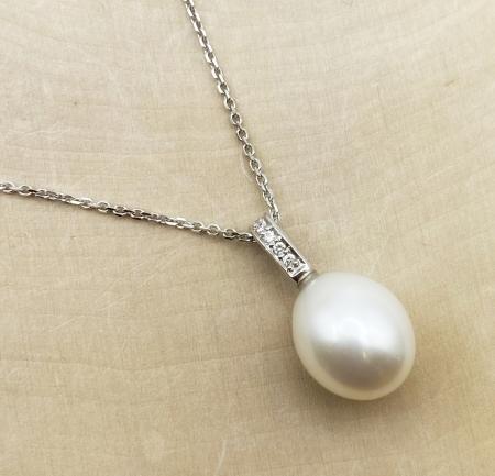 14 karat white gold oval freshwater cultured pearl and diamond necklace. $810.00