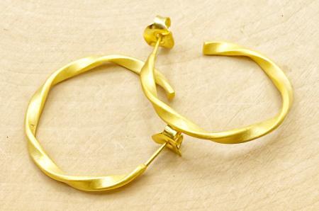 Sterling silver and 18 karat gold vermeil twist hoops. $156.00