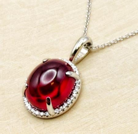 14 karat white gold pendant with a 8.14 carat cabochon cut lab created ruby and diamond accents. $1,890.00
