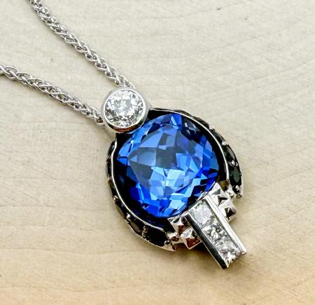 18 karat white gold cushion cut iolite, blue sapphire and diamond necklace. $2,450.00