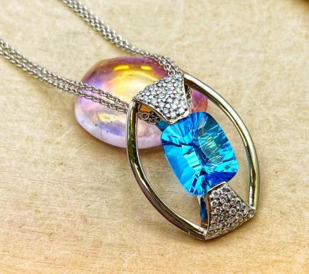 18 karat white and rose gold 4.87 carat concave faceted cushion Swiss blue topaz and diamond necklace. 550-13666