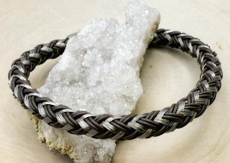 Stainless steel and rubber braided bracelet. $60.00