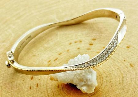 Sterling silver, 18 karat gold and diamond bangle bracelet. $1376.00