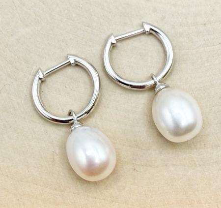 Sterling silver huggie hoop earrings with oval freshwater pearl dangles. $168.00