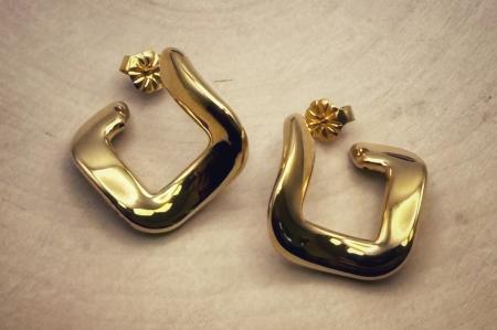 Sterling silver 22 karat yellow gold vermeil twist style hoops. $145.00