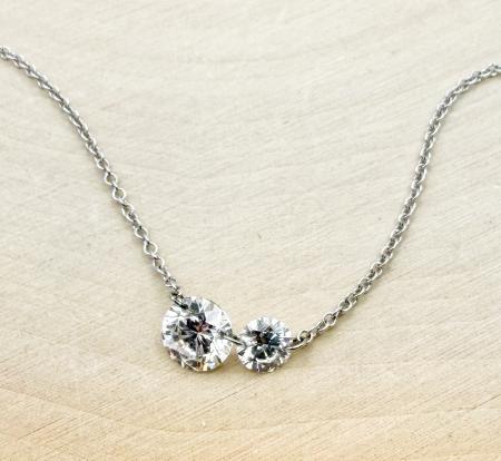 14 karat white gold "floating" diamond necklace with two brilliant cut lab grown diamonds totaling 0.74 carat. $1500.00