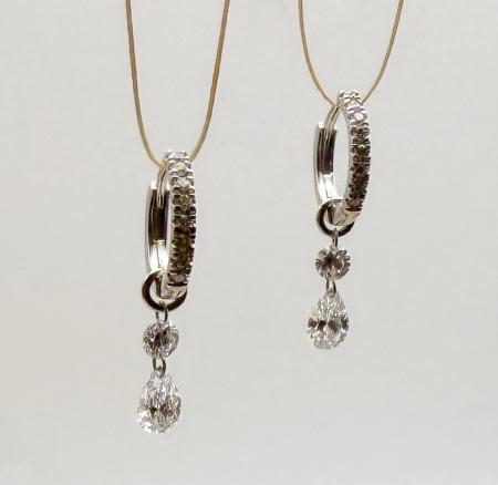 14 karat white gold diamond huggies with two round and two pear shape "floating" diamonds totaling 0.96 carat. $2100.00