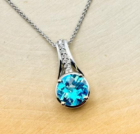 14 karat white gold 3.40 carat round checkerboard cut Swiss blue topaz and diamond necklace. $2,150.00