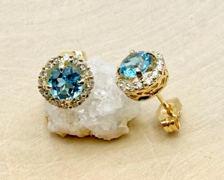14 karat yellow gold Swiss blue topaz and diamond halo earrings. $995.00