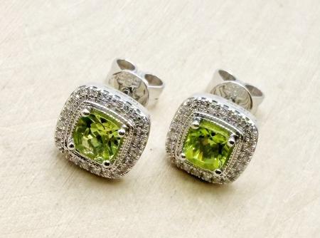 14 karat white gold cushion peridot and diamond halo earrings. $995.00