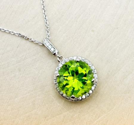 14 karat white gold 4.10 carat round peridot and diamond halo necklace. $1725.00