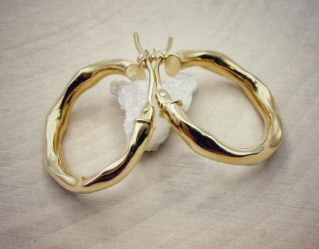 14 karat yellow gold 20mm x 3mm twist hoop earrings. $357.00
