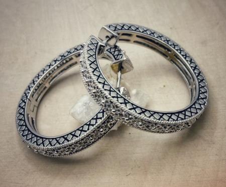 Sterling silver filigree hoop earrings. $150.00