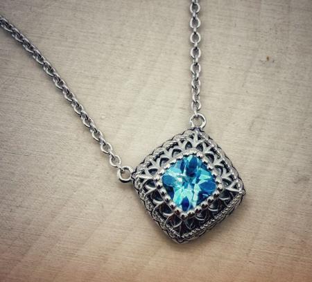 Sterling silver and cushion checkerboard cut Swiss blue topaz necklace. $275.00