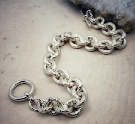 Sterling silver engraved rollo link toggle bracelet. $400.00