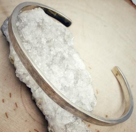 Hand made, sterling silver hammered cuff bracelet with a brushed finish. $280.00