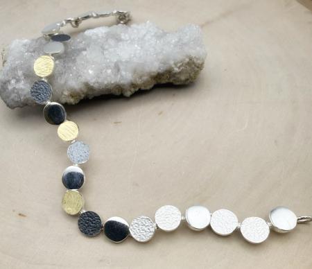 Oxidized sterling silver and 18 karat gold vermeil disc link bracelet. $1080.00