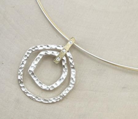 Sterling silver and 18 karat gold vermeil hammered circles necklace with diamond accents. $470.00