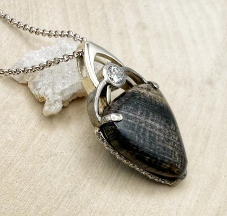 Sterling silver petrified oak and diamond necklace. $990.00