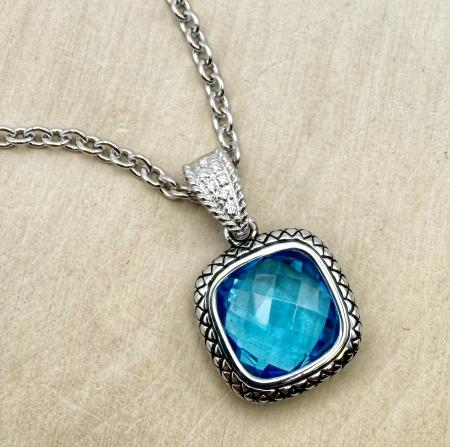 Sterling silver necklace with a checkerboard cut Swiss blue topaz and diamond accents. $700.00