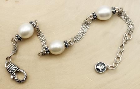 Sterling silver and oval freshwater cultured pearl bracelet. $275.00