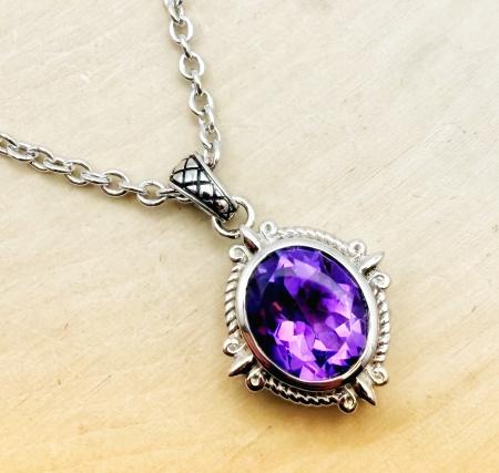 Sterling silver and oval faceted amethyst necklace. $400.00