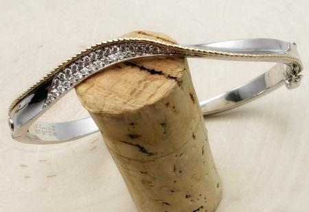 Sterling silver, 18 karat gold accent and diamond wave bracelet. $1100.00