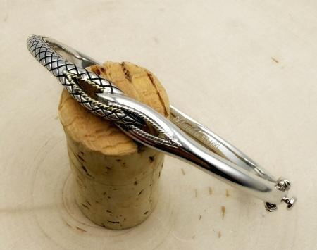 Sterling silver and 18 karat gold accent interlocking design bangle bracelet. $250.00