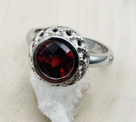Sterling silver and round checkerboard cut garnet ring. $150.00