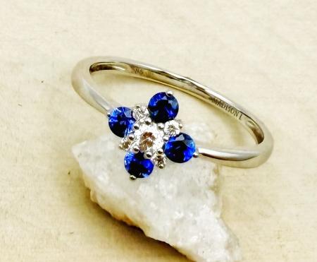 14 karat white gold sapphire and diamond cluster design ring. $1015.00